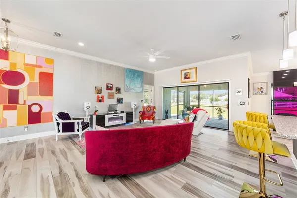 a living room with furniture and kitchen view