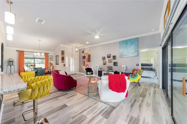 a dining room with furniture a rug and wooden floor