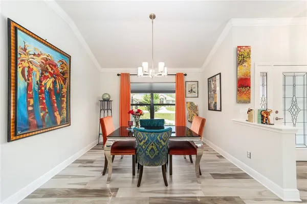 a view of a dining room with furniture wooden floor and chandelier