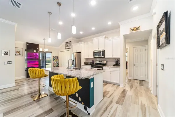 a kitchen with stainless steel appliances granite countertop a stove oven and a sink with cabinets