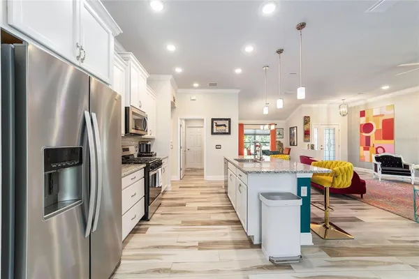 a kitchen that has a lot of cabinets in it