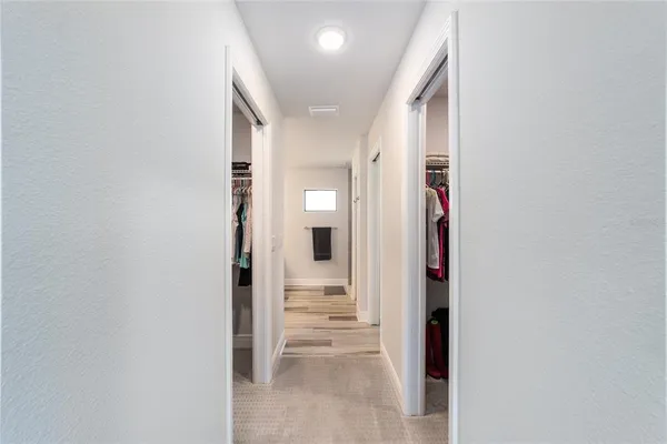 a living room with furniture and a bookshelf