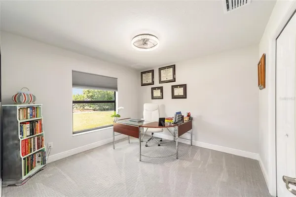 a living room with furniture and a large window with garden view