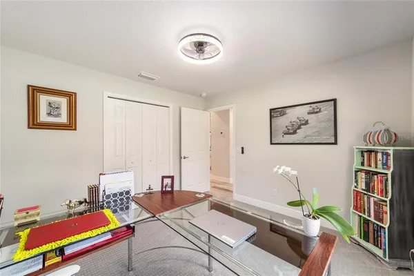 a living room with a floor to ceiling window next to a yard