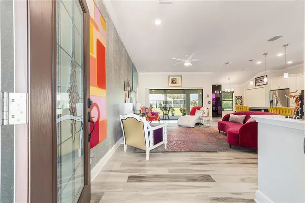 a living room filled with furniture and a wooden floor