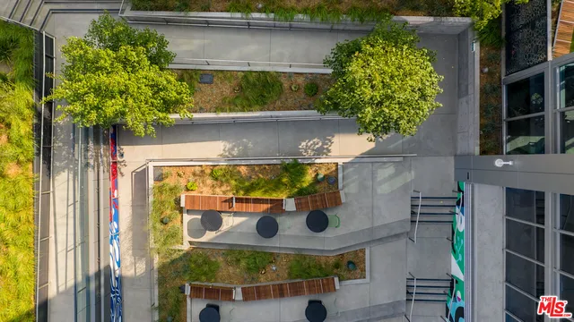 a view of a patio with table and chairs potted plants