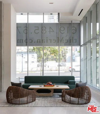 a living room with lots of furniture and a floor to ceiling window