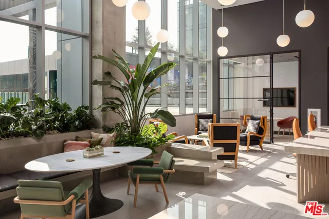 a view of a patio with dining table and chairs