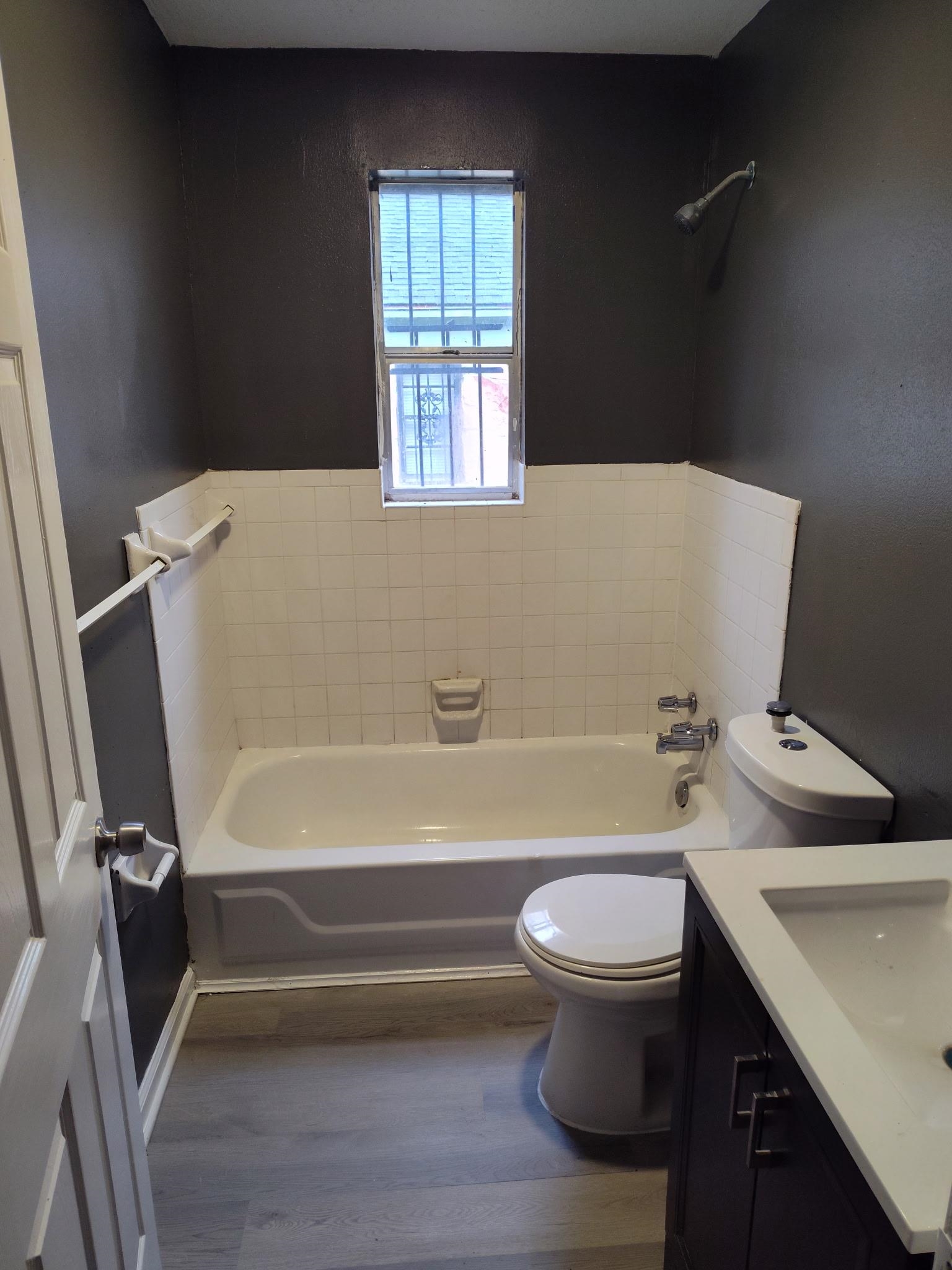 258 Silverage Avenue Memphis, TN 38109 - Photo 2 of 8 Bathroom featuring vanity, wood finished floors, and shower combination