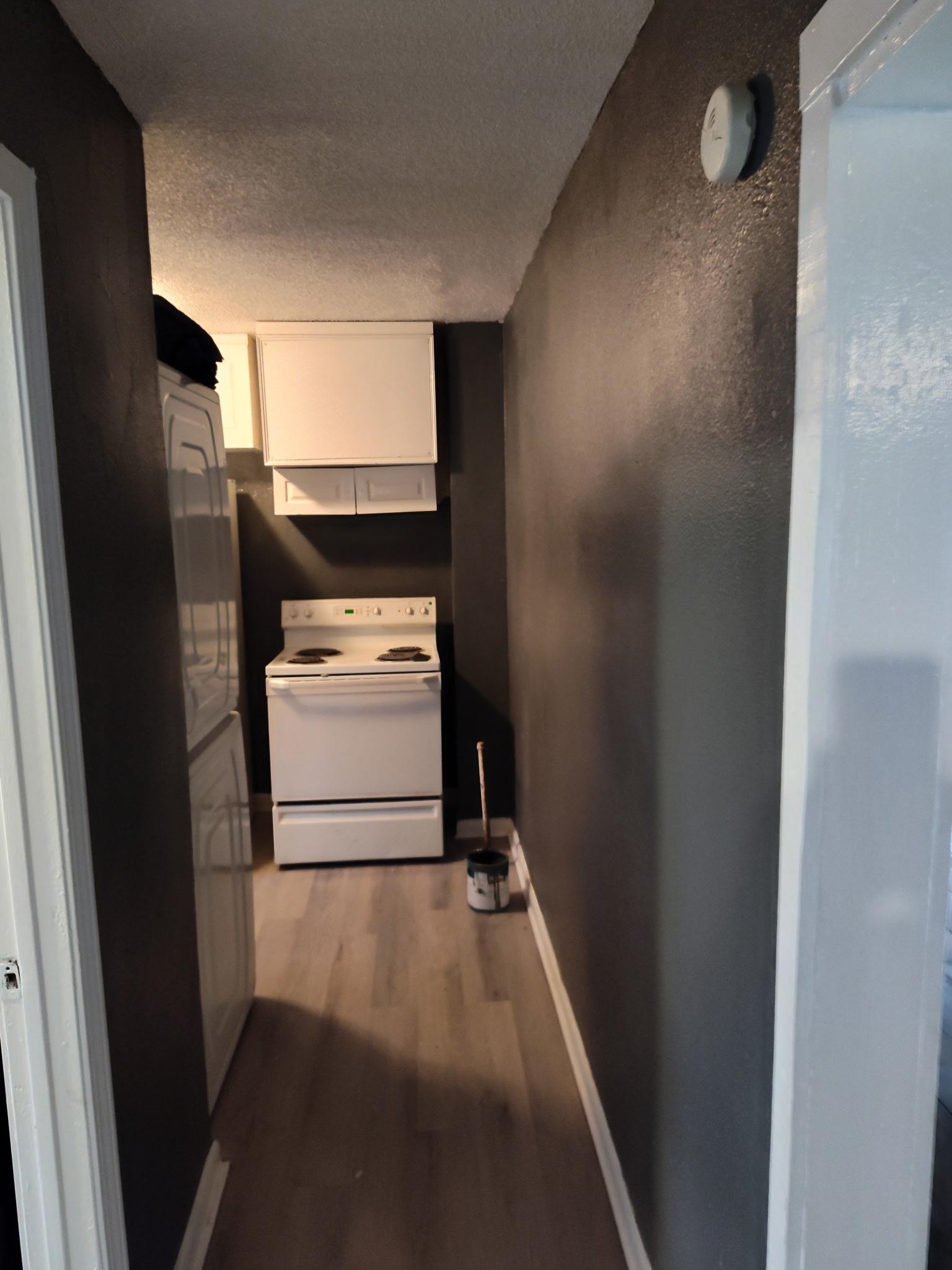 258 Silverage Avenue Memphis, TN 38109 - Photo 3 of 8 Hallway featuring light wood-style flooring and a textured ceiling