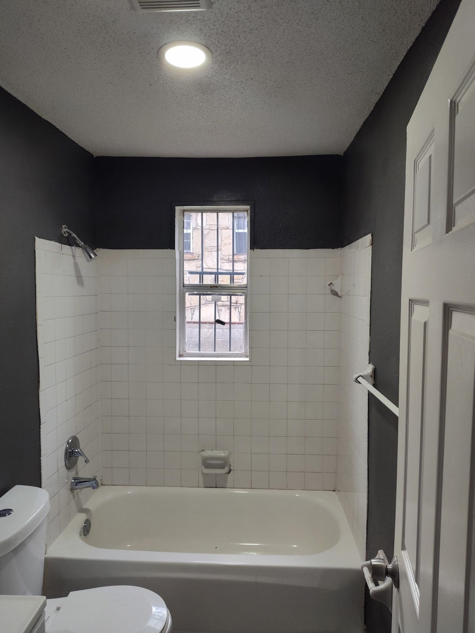 258 Silverage Avenue Memphis, TN 38109 - Photo 8 of 8 Bathroom with bathing tub / shower combination and a textured ceiling