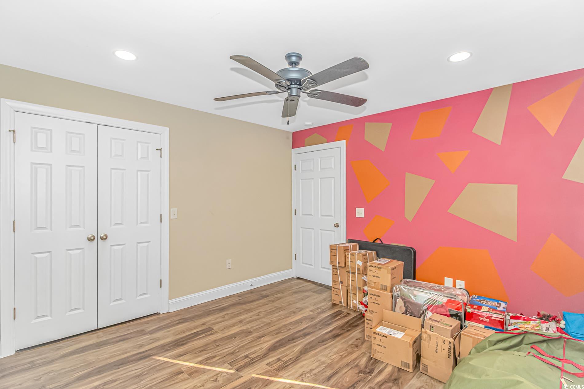 4106 Edwards Road Aynor, SC 29511 - Photo 22 of 39 Bedroom with ceiling fan, a closet, and wood-type