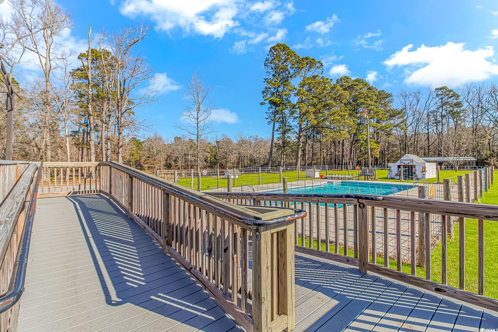 4106 Edwards Road Aynor, SC 29511 - Photo 26 of 39 Wooden terrace with a covered pool, a storage unit