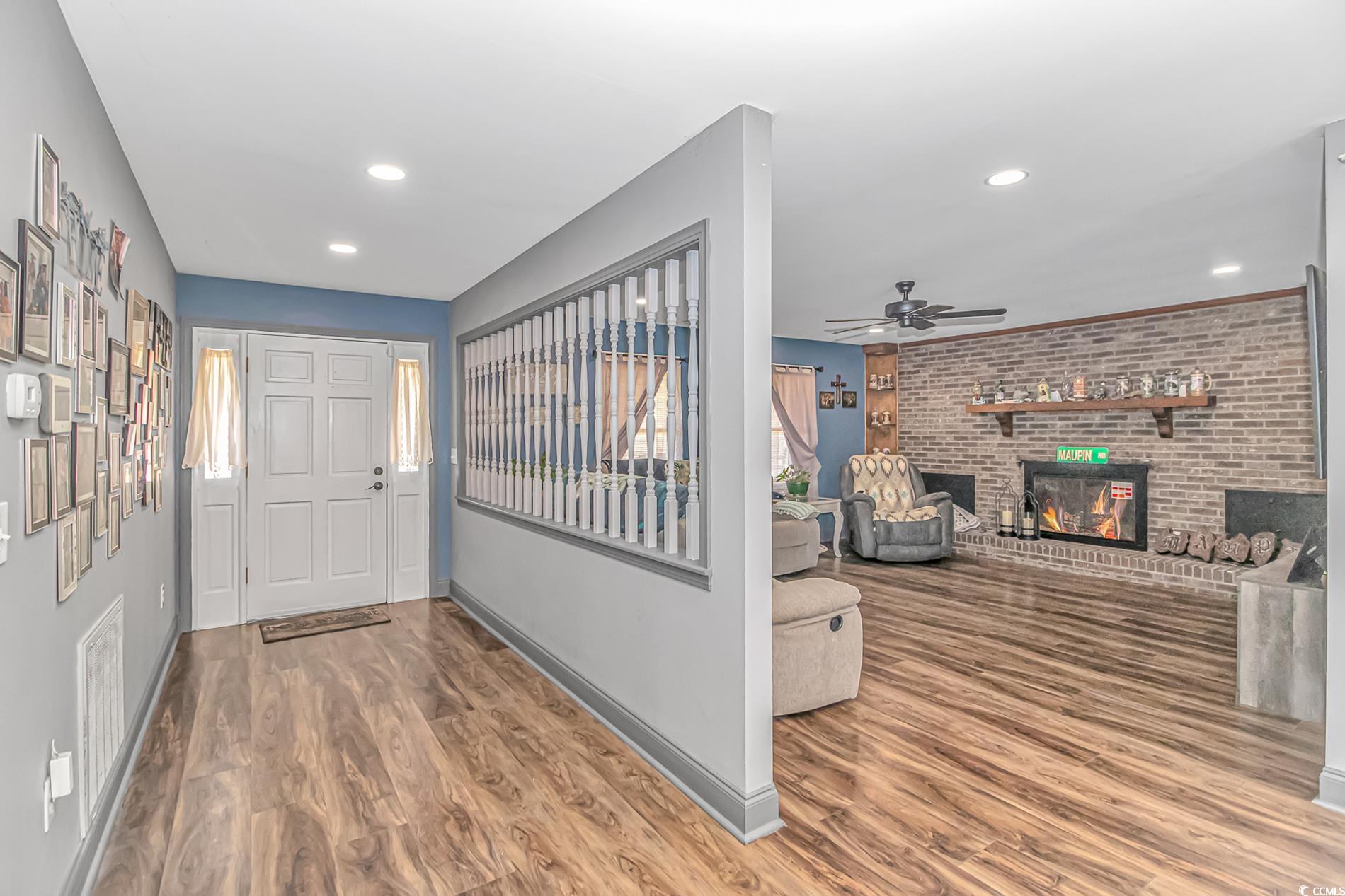 4106 Edwards Road Aynor, SC 29511 - Photo 4 of 39 Foyer entrance featuring a fireplace, wood-type fl