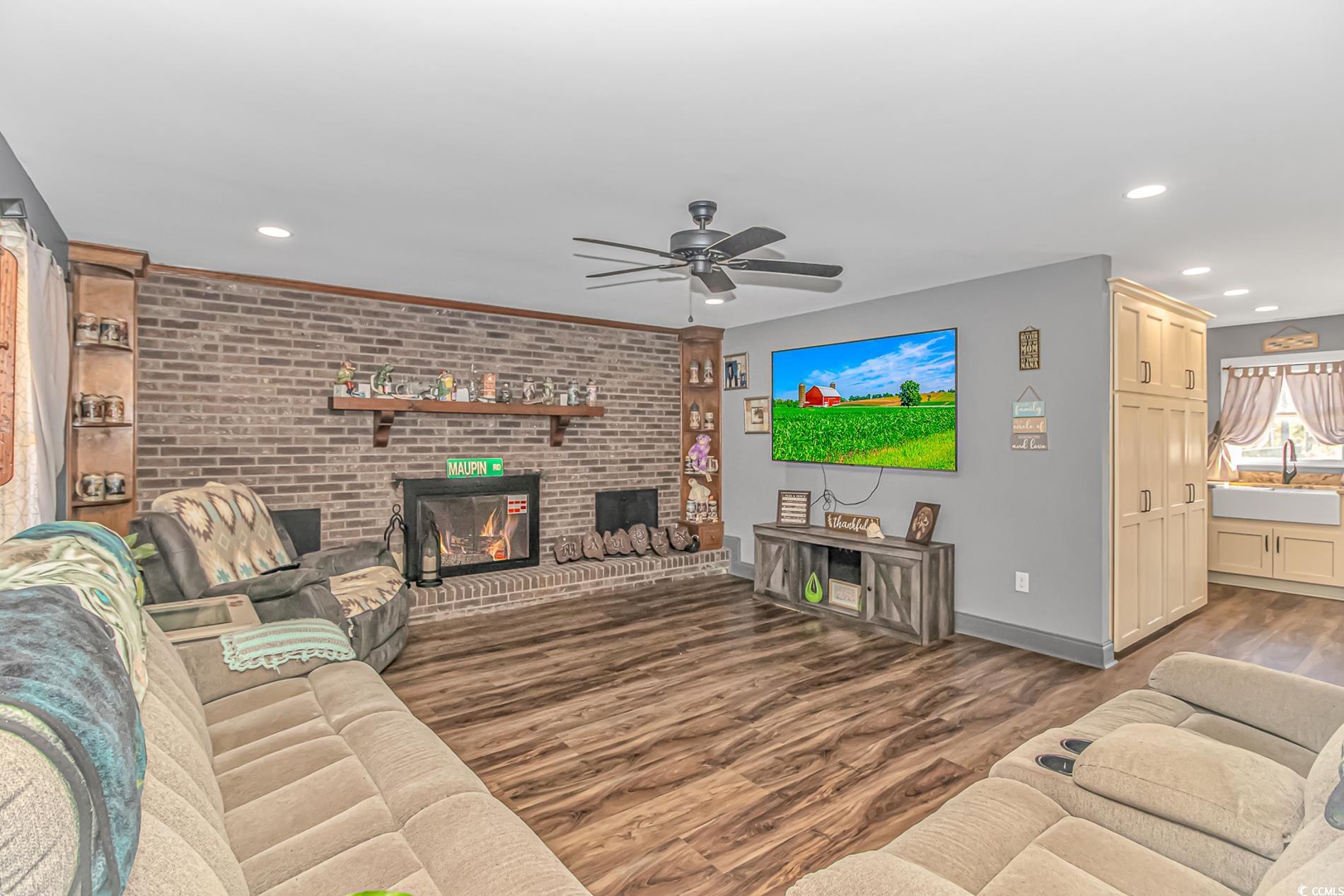 4106 Edwards Road Aynor, SC 29511 - Photo 6 of 39 Living room featuring ceiling fan, sink, a firepla
