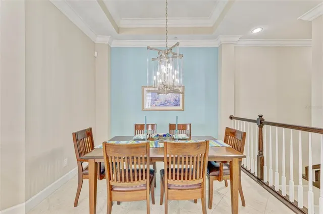 a view of a white house next to a road and yard