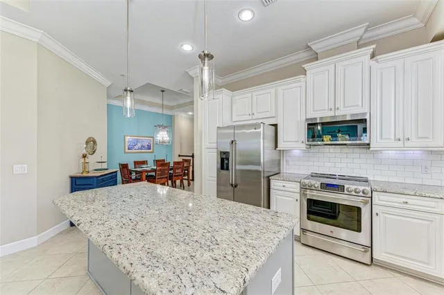 a dining room with furniture a chandelier and wooden floor