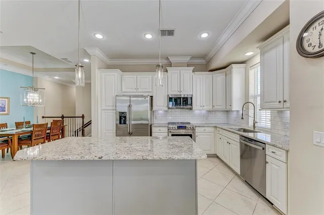 a view of a patio with table and chairs a barbeque with potted plants