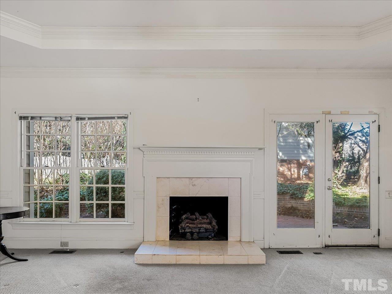 2016 Carrbridge Way Raleigh, NC 27615 - Photo 13 of 53 a living room with a fireplace and a large window