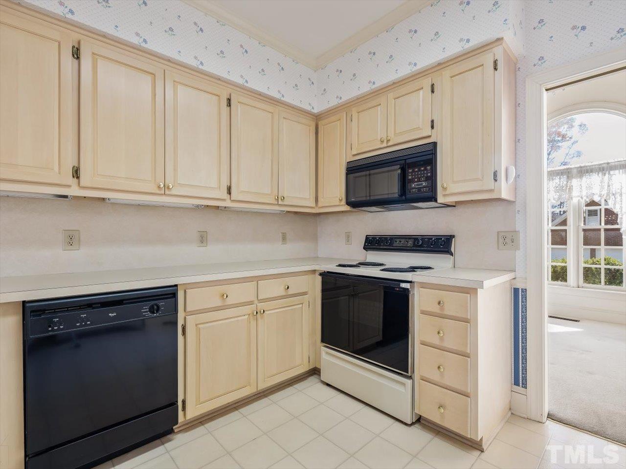 2016 Carrbridge Way Raleigh, NC 27615 - Photo 18 of 53 a kitchen with granite countertop white cabinets and stainless steel appliances