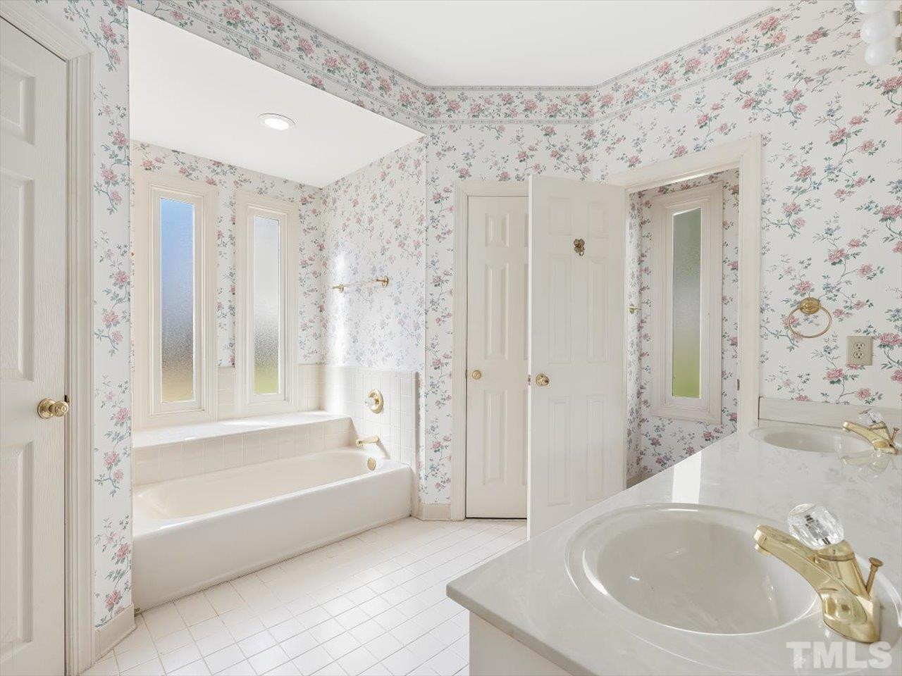 2016 Carrbridge Way Raleigh, NC 27615 - Photo 25 of 53 a bathroom with a bathtub and a sink