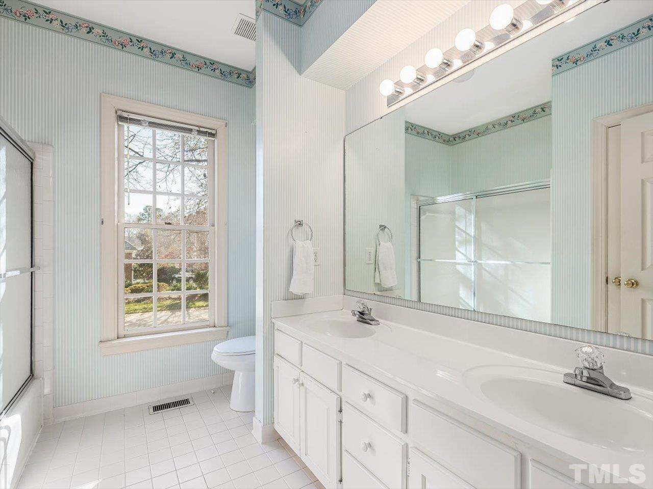 2016 Carrbridge Way Raleigh, NC 27615 - Photo 33 of 53 a bathroom with a double vanity sink toilet and a mirror