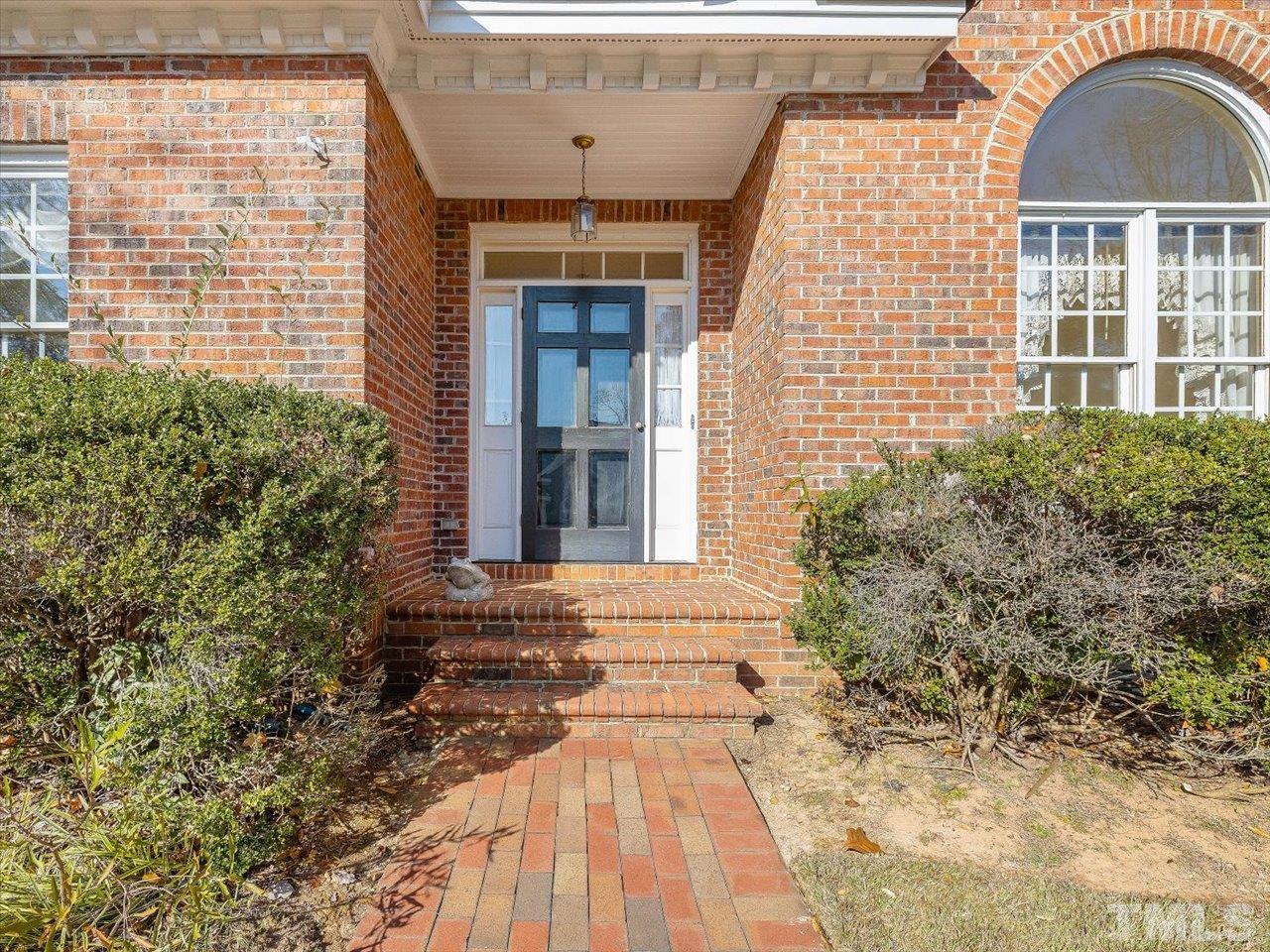 2016 Carrbridge Way Raleigh, NC 27615 - Photo 6 of 53 a view of a brick house with a yard