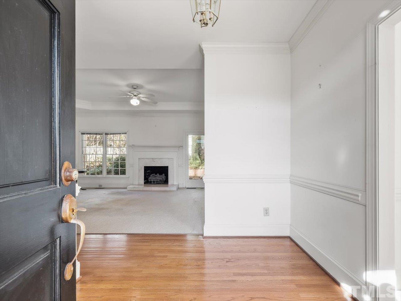2016 Carrbridge Way Raleigh, NC 27615 - Photo 7 of 53 a view of a livingroom with a fireplace a window and wooden floor