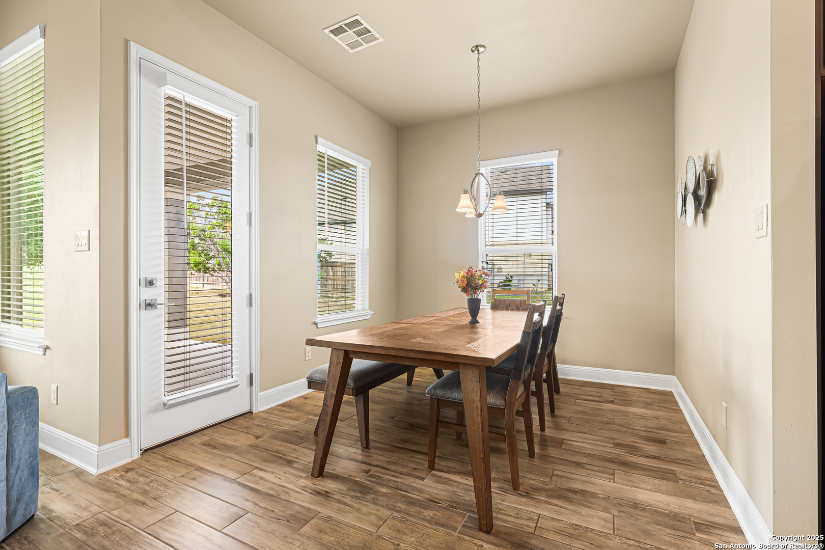 27103 Coltons Canyon San Antonio, TX 78260 - Photo 12 of 42 a view of a dining room with furniture window and wooden floor