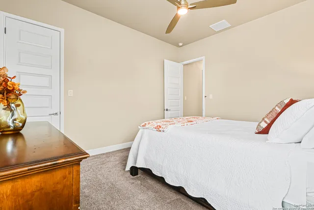 a bedroom with a bed and a dresser