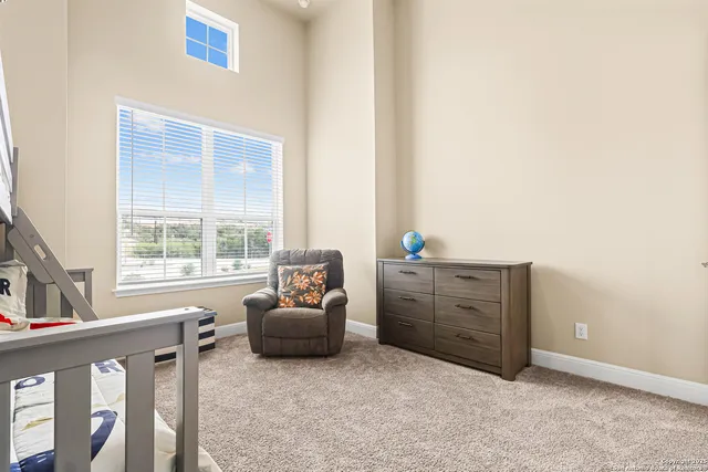a bed room with furniture and windows