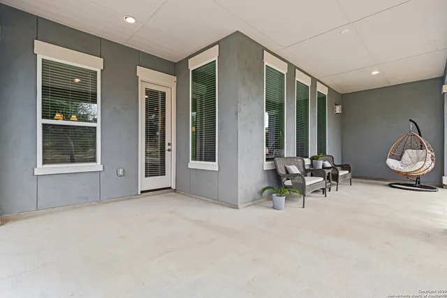 a view of a porch with furniture and garden
