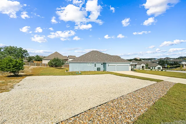 a view of an house with swimming pool and mountains in the background