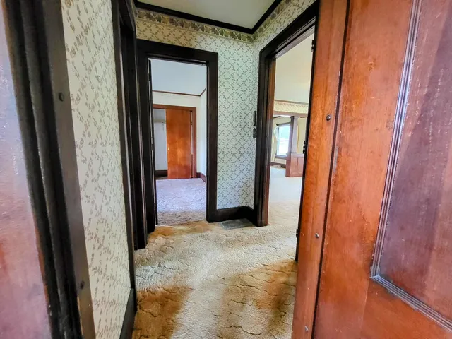 an empty room with windows and closet