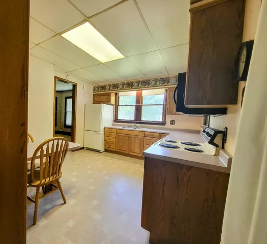 a kitchen that has a sink and a stove in it
