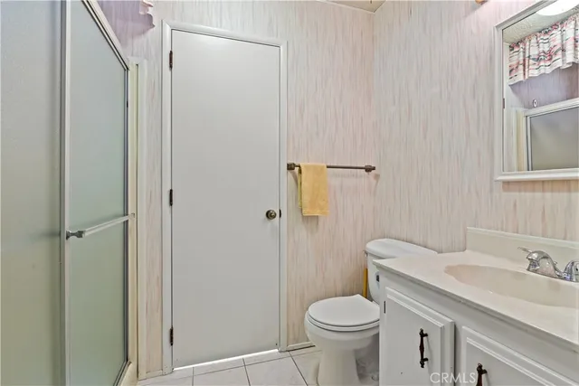a white toilet sitting next to a bathroom sink
