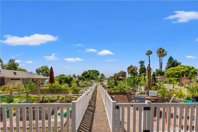 a view of a kitchen with appliances wooden floor and a counter top space