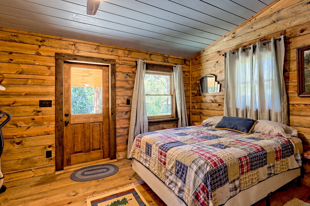 1064 Muskrat Creek Road Hayesville, NC 28904 - Photo 20 of 67 a bedroom with a bed next to a window