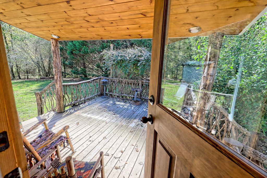 1064 Muskrat Creek Road Hayesville, NC 28904 - Photo 25 of 67 a view of a balcony with floor to ceiling windows with wooden floor