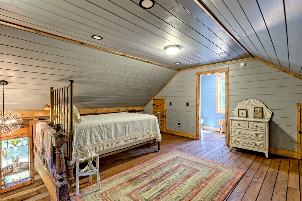 1064 Muskrat Creek Road Hayesville, NC 28904 - Photo 29 of 67 a bedroom with bed and wooden floor