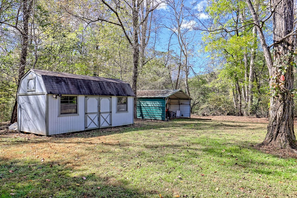 1064 Muskrat Creek Road Hayesville, NC 28904 - Photo 41 of 67 a view of a house with backyard and tree
