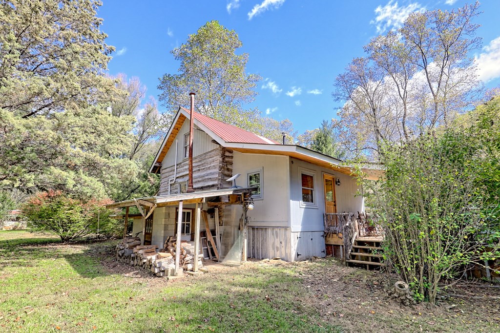 1064 Muskrat Creek Road Hayesville, NC 28904 - Photo 51 of 67 a view of a house with a yard and sitting area
