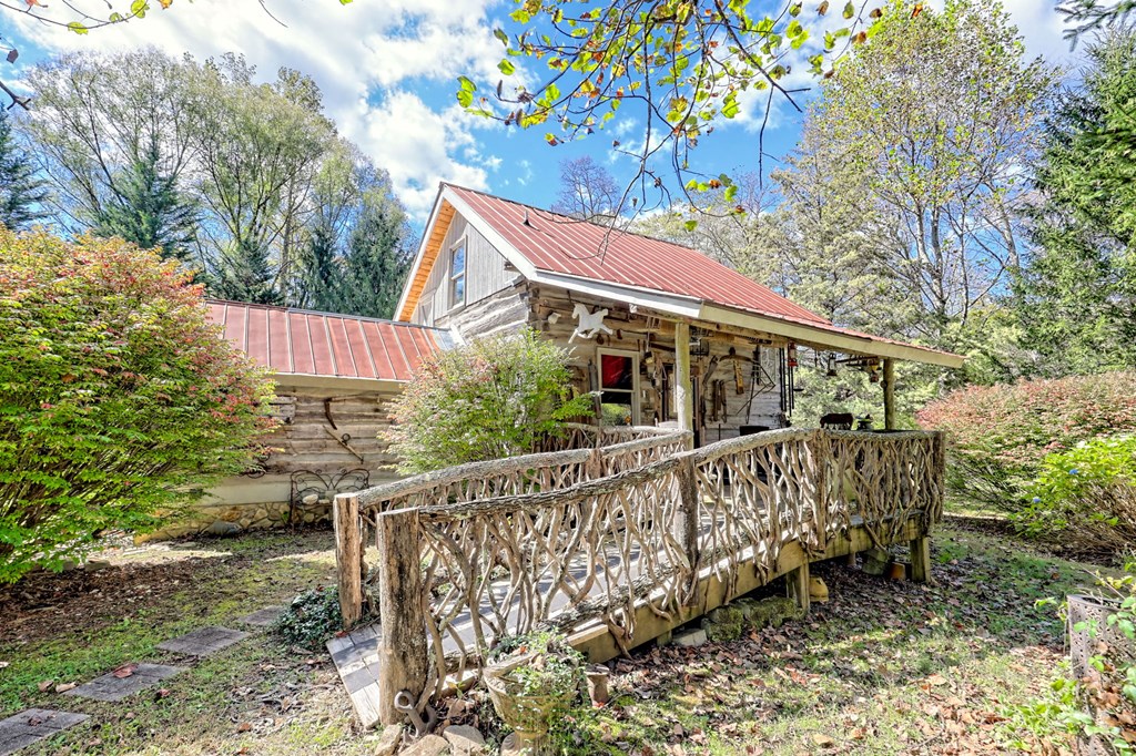 1064 Muskrat Creek Road Hayesville, NC 28904 - Photo 7 of 67 a view of house with outdoor seating and green space