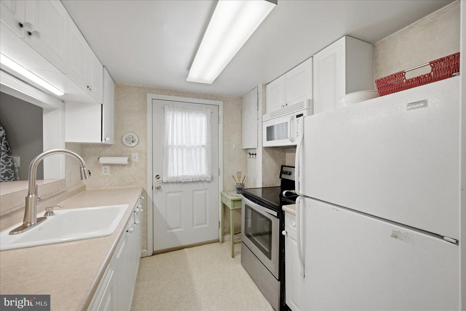 165 Wilson Burke Road Front Royal, VA 22630 - Photo 23 of 134 a kitchen with a refrigerator sink and white cabinets