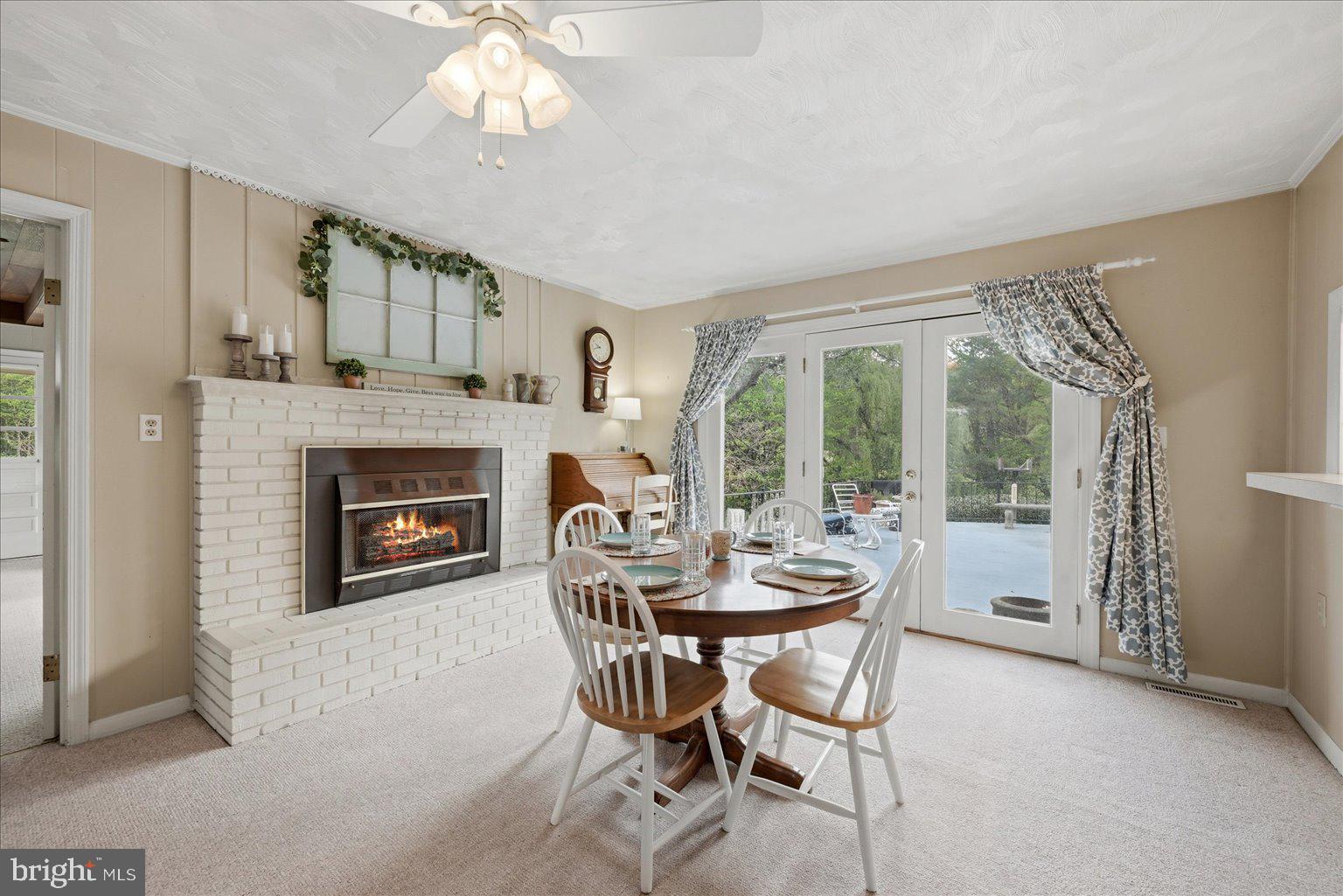 165 Wilson Burke Road Front Royal, VA 22630 - Photo 25 of 134 a dining room with furniture a fireplace and large windows