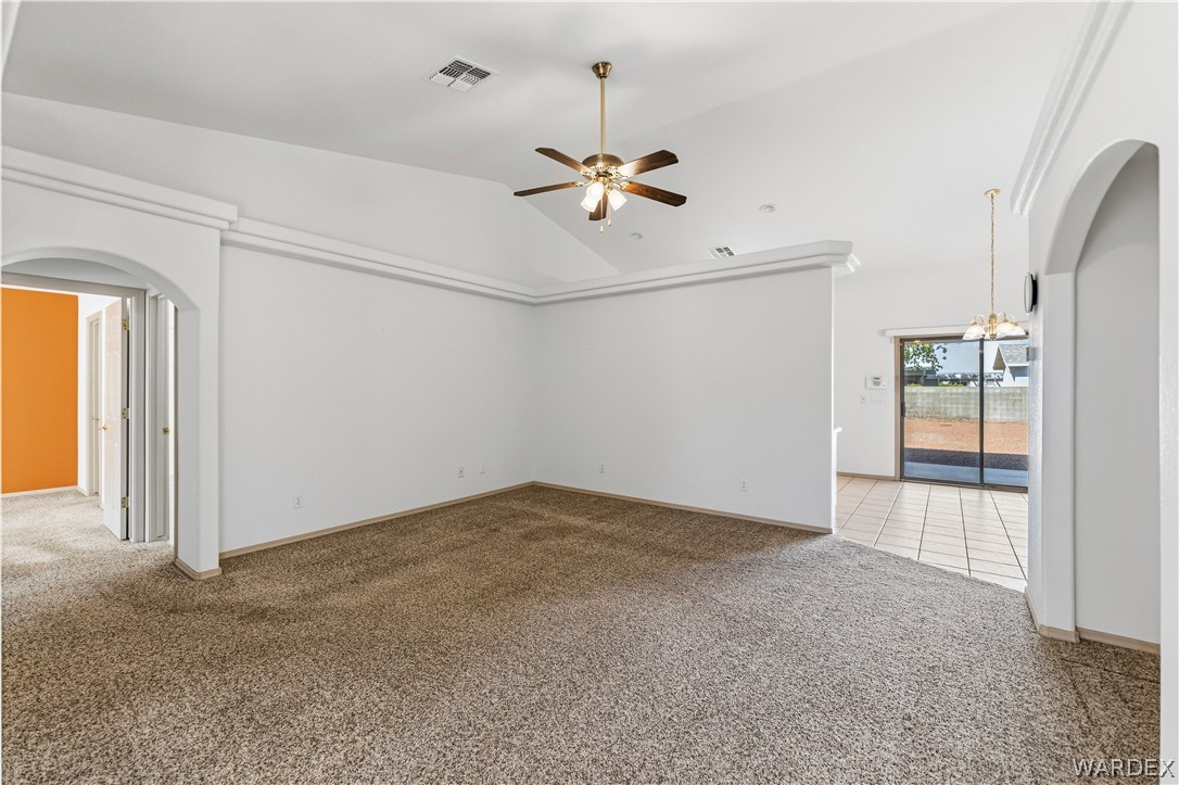 3973 Prairie View Drive Kingman, AZ 86409 - Photo 11 of 34 Spacious room featuring vaulted ceilings, a ceiling fan, and carpeted flooring