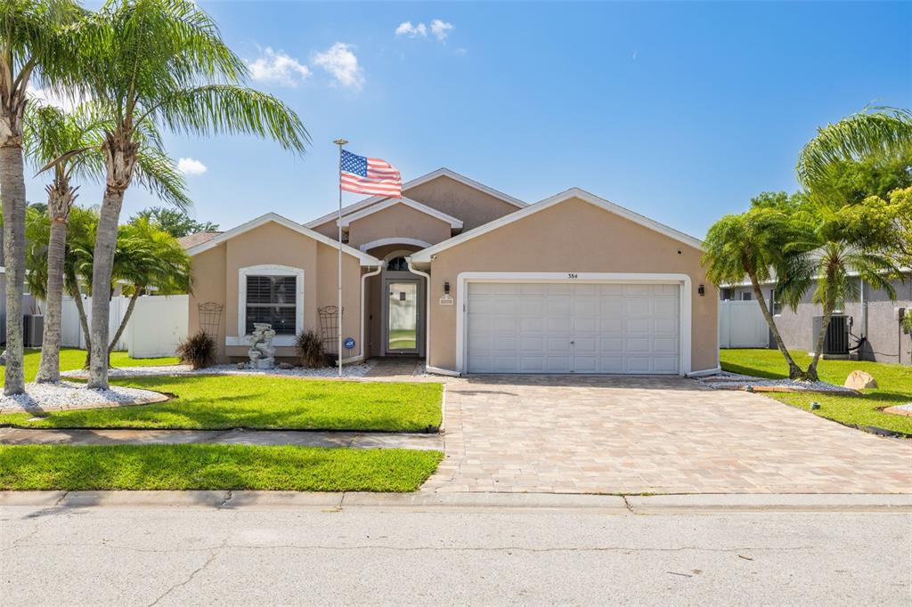 a front view of a house with a garden and plants