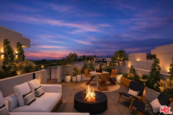 a view of a balcony with couches and a table