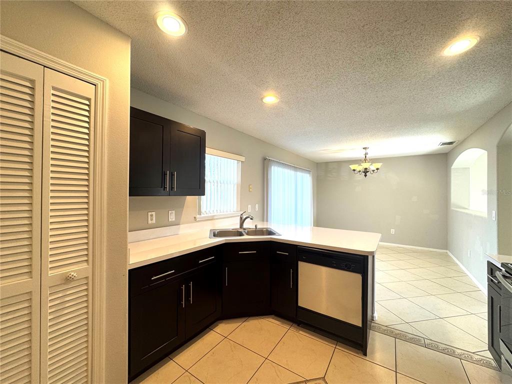 14328 Rainsong Drive Orlando, FL 32824 - Photo 11 of 27 a kitchen with a sink and cabinets