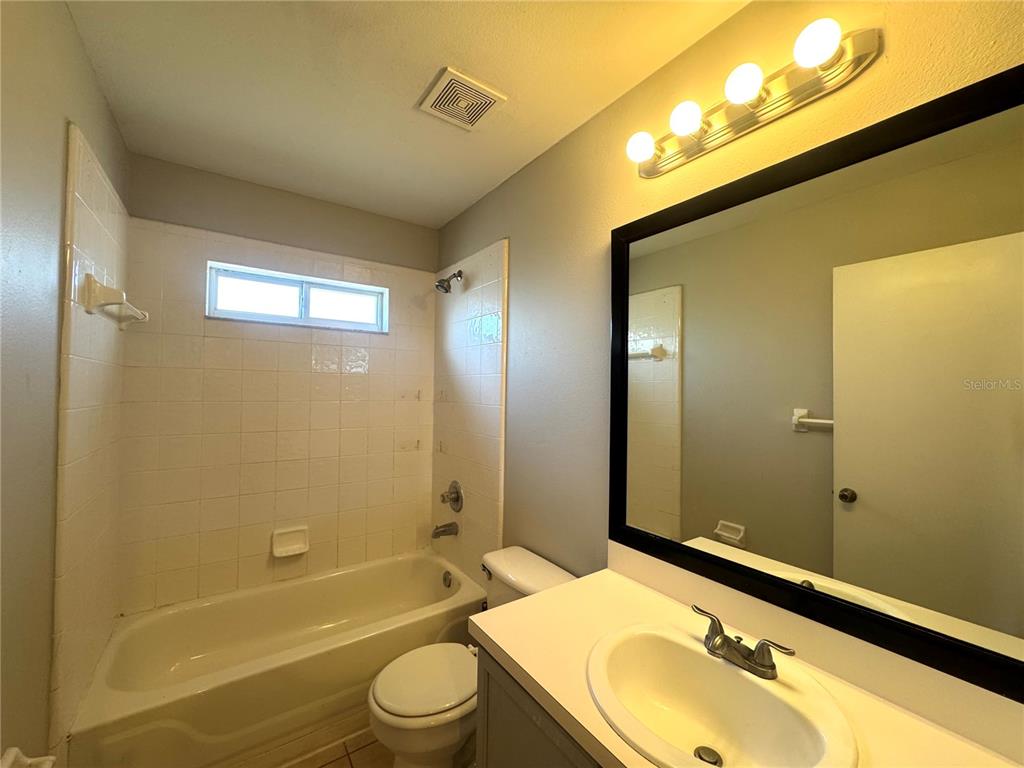 14328 Rainsong Drive Orlando, FL 32824 - Photo 16 of 27 a bathroom with a sink mirror toilet and bathtub